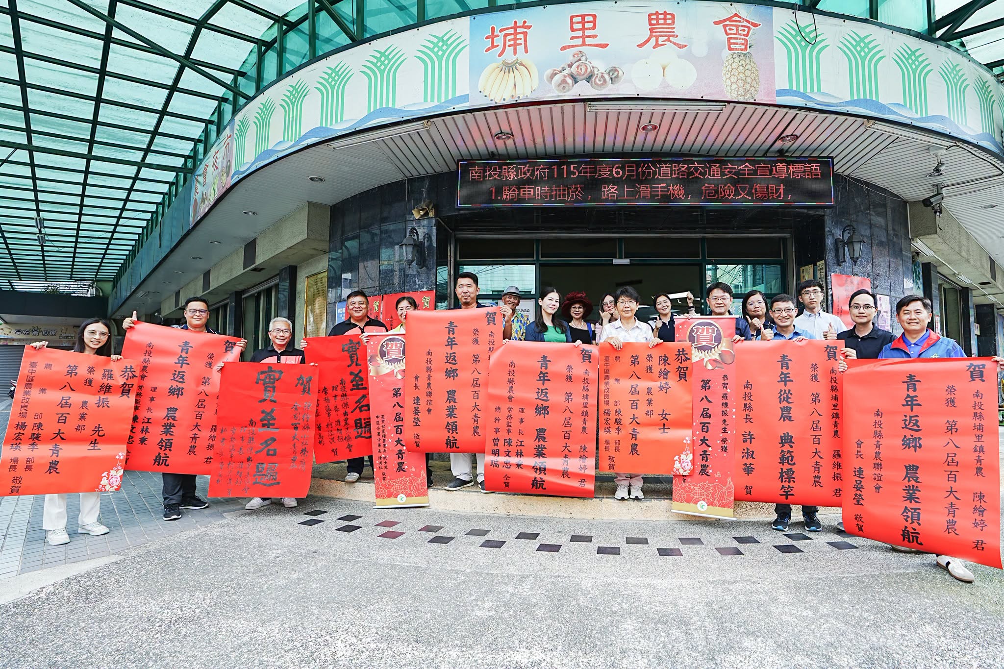 本場楊宏瑛場長(中右1)與農業推廣科吳建銘科長(右2)等人前往埔里鎮農會張貼紅榜,祝賀青農陳繪婷(中)、羅維振(中左1)獲選農業部第八屆百大青農殊榮。
